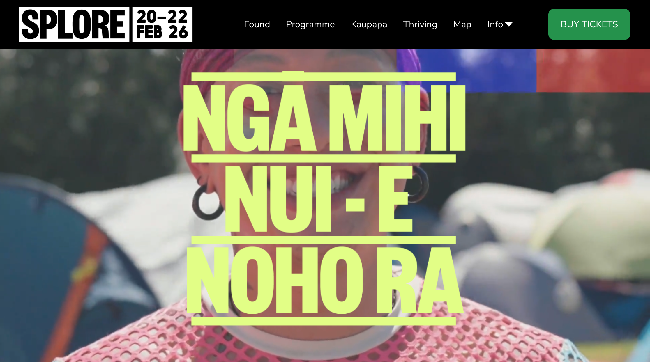 Splore festival homepage with full-width aerial photograph of beachside festival grounds at Tāpapakanga Regional Park, bright colored hero headline and Buy Tickets button in navigation bar