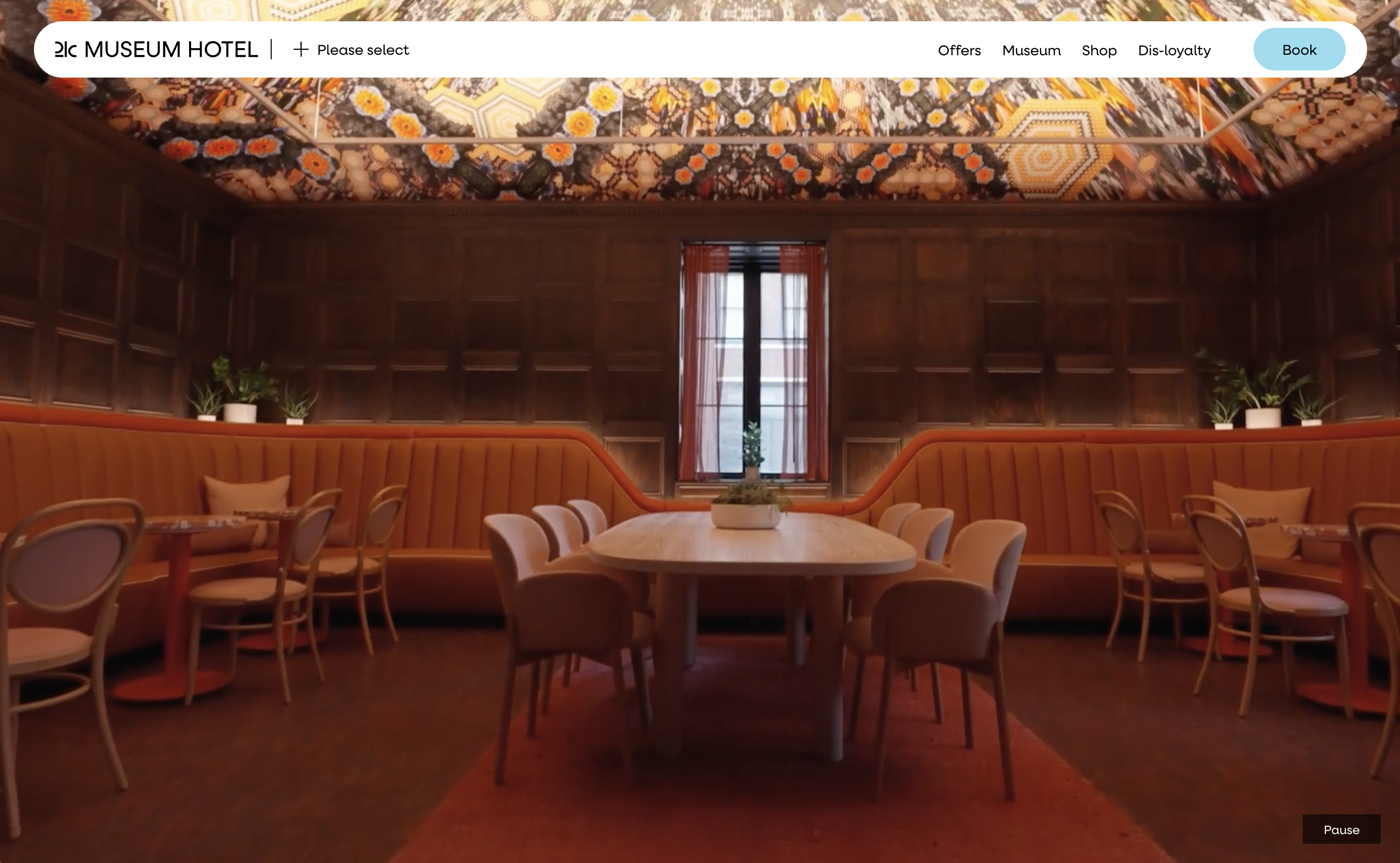 21c Museum Hotel homepage hero banner, stylish art-filled restaurant interior background, top navigation menu with booking button, museum boutique hotel dining space featuring bold patterned ceiling and orange booth seating