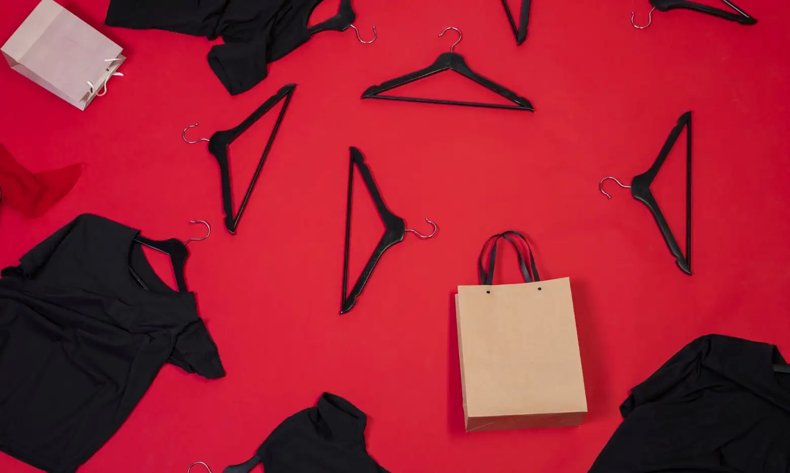 Black clothes hangers, brown bags and black T-shirts