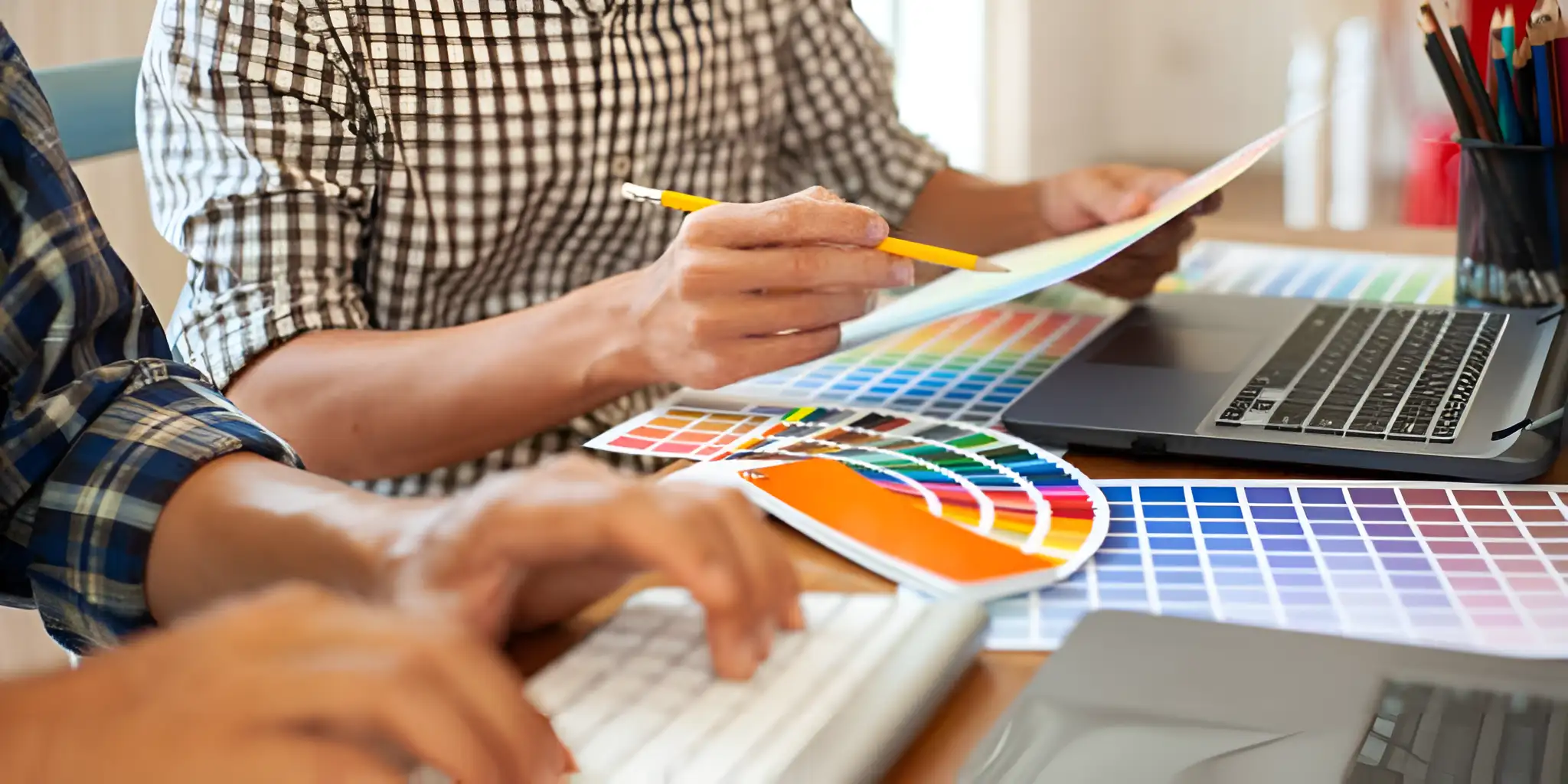 people designing the color layout of a web page on a draft
