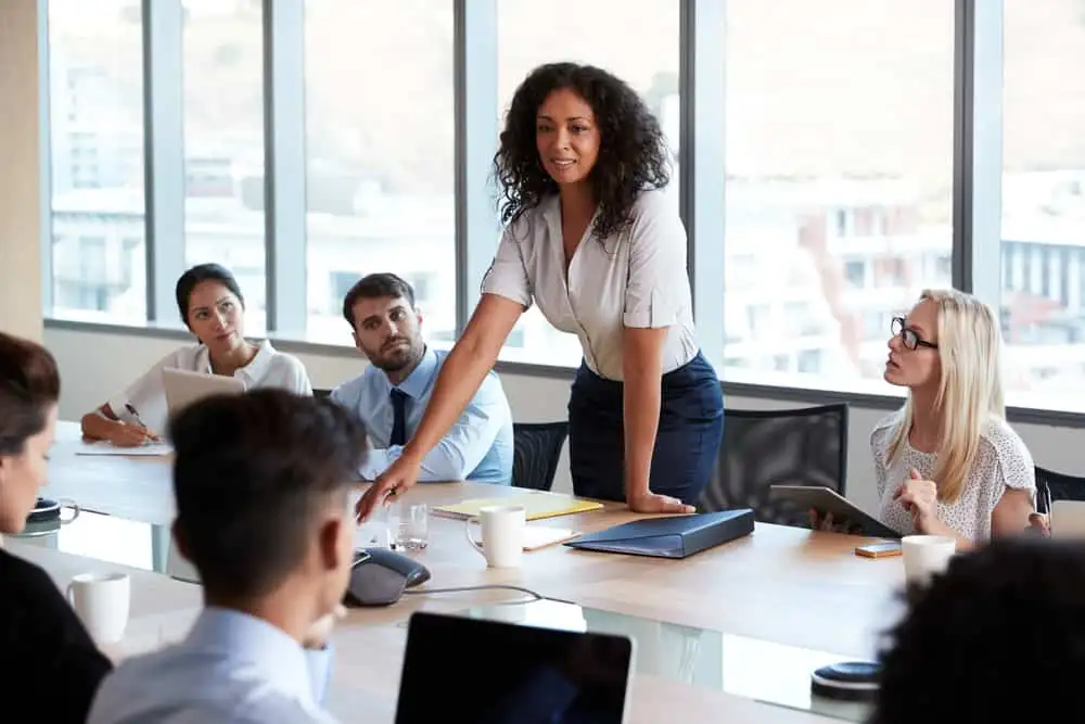 A female entrepreneur demonstrating leadership skills while leading a team meeting. A female entrepreneur demonstrating leadership skills while leading a team meeting.