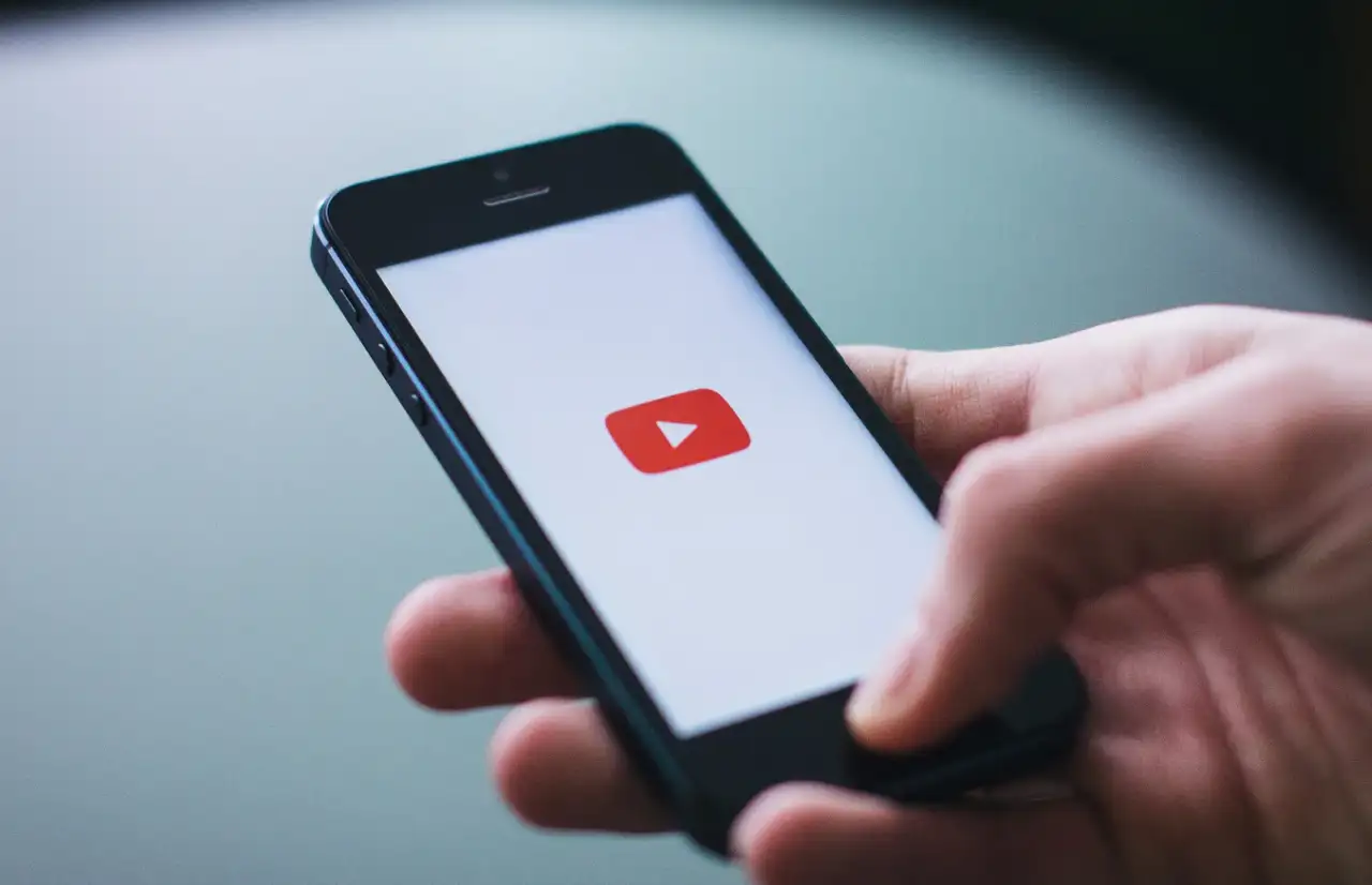 a man open youtube app on a phone