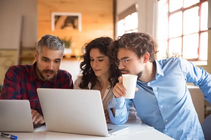 A group of friends having fun and curing boredom by exploring interactive websites on a laptop. A group of friends having fun and curing boredom by exploring interactive websites on a laptop.