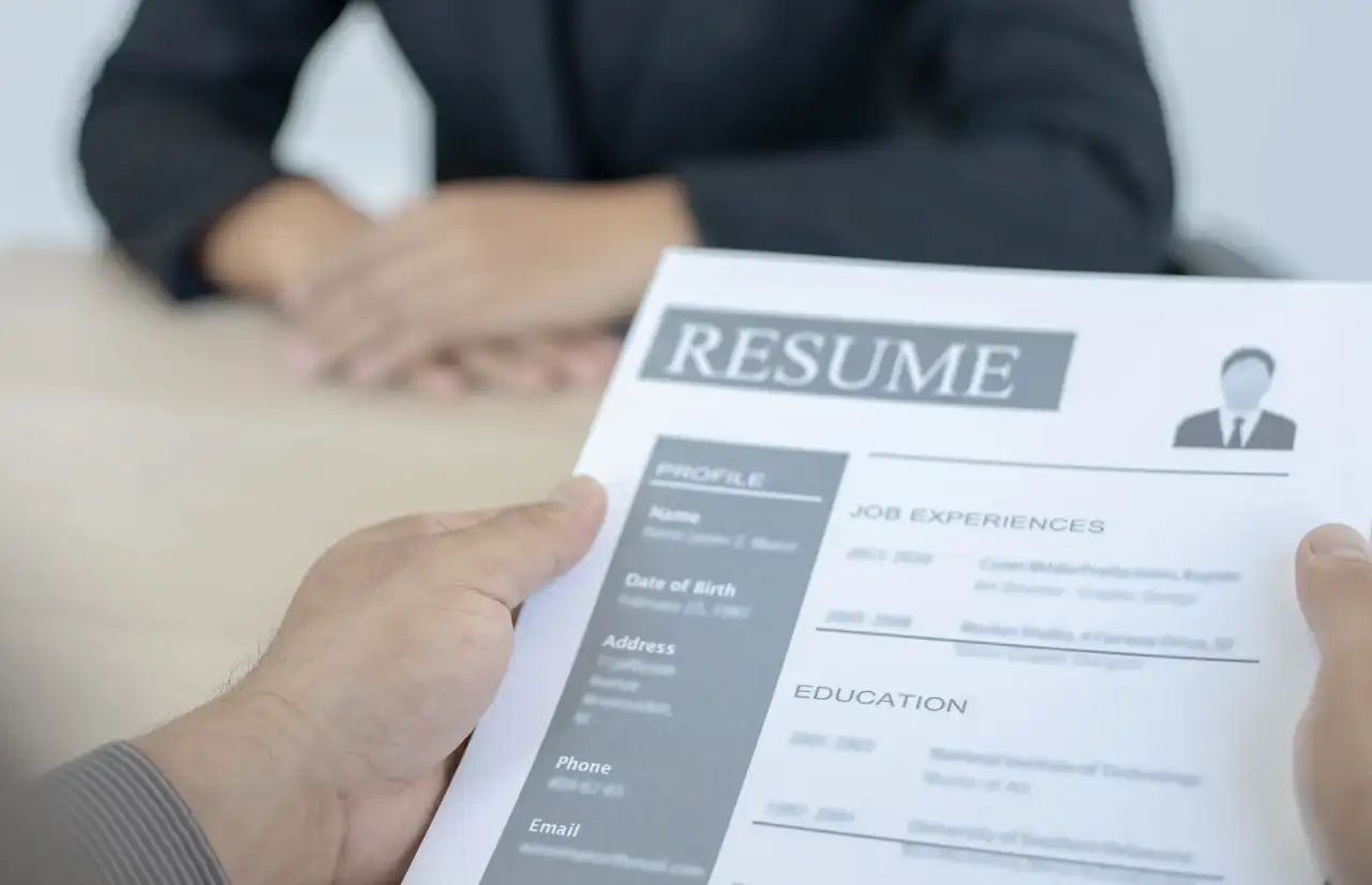 hands holding a resume