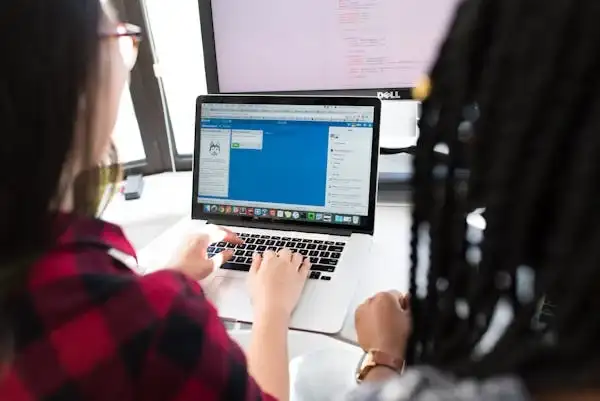 a person is tutoring online using laptop