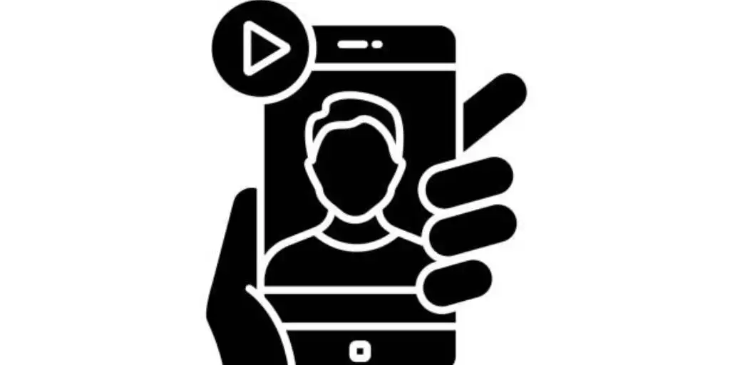 A hand holding a mobile phone playing a video