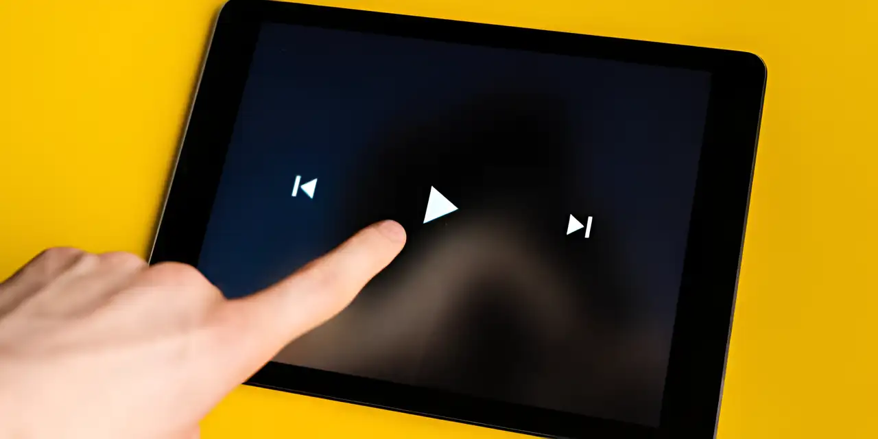 one finger taps the play button