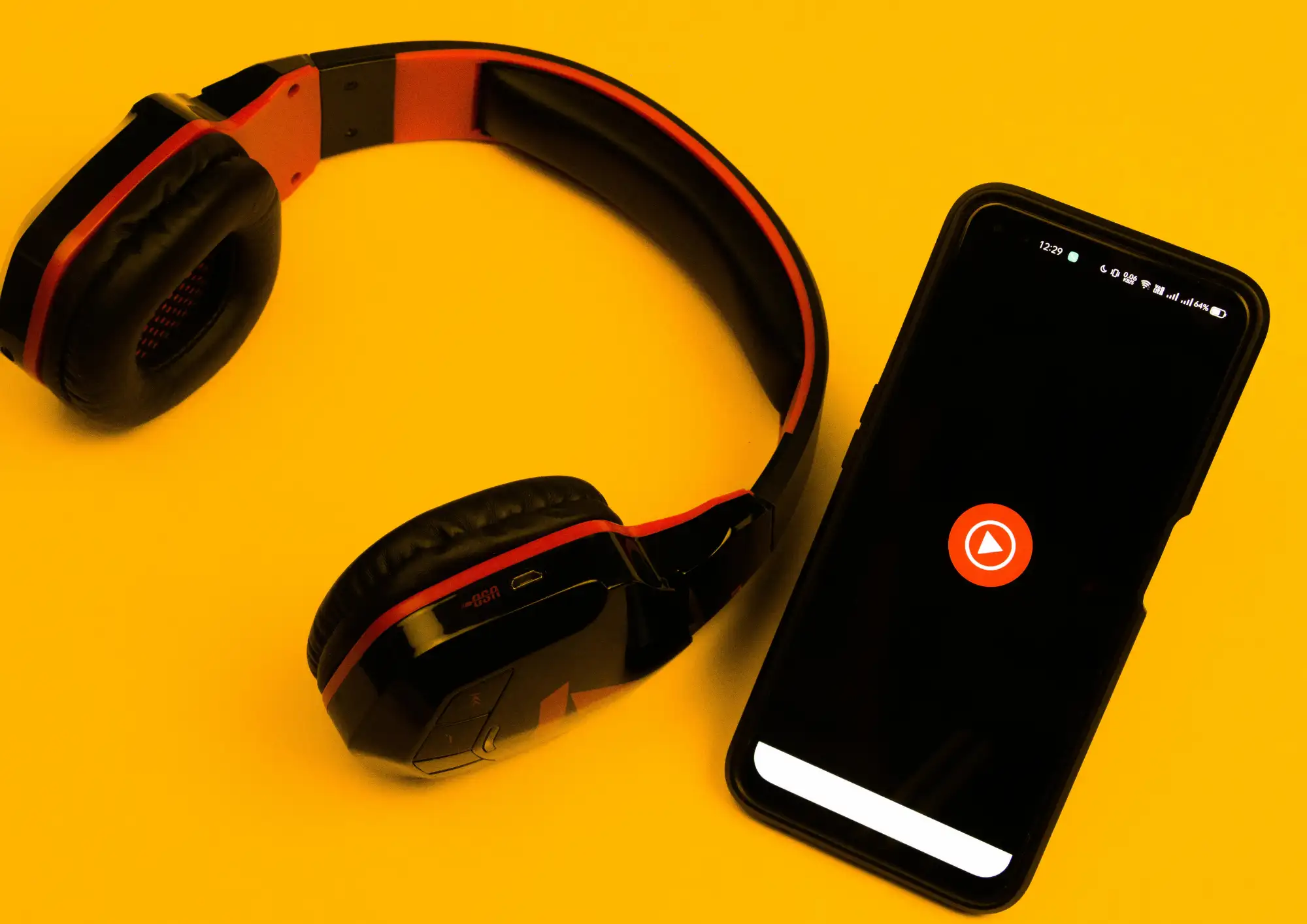 a headphone and a phone showing a youtube video