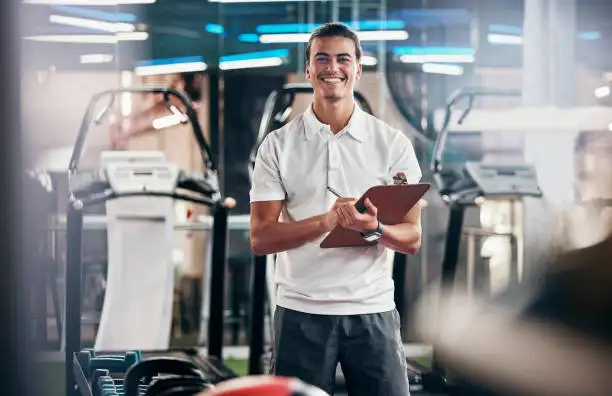 a fitness coach smiling at a gym