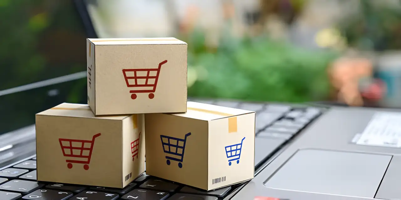 three e-commerce shopping boxes on the keyboard