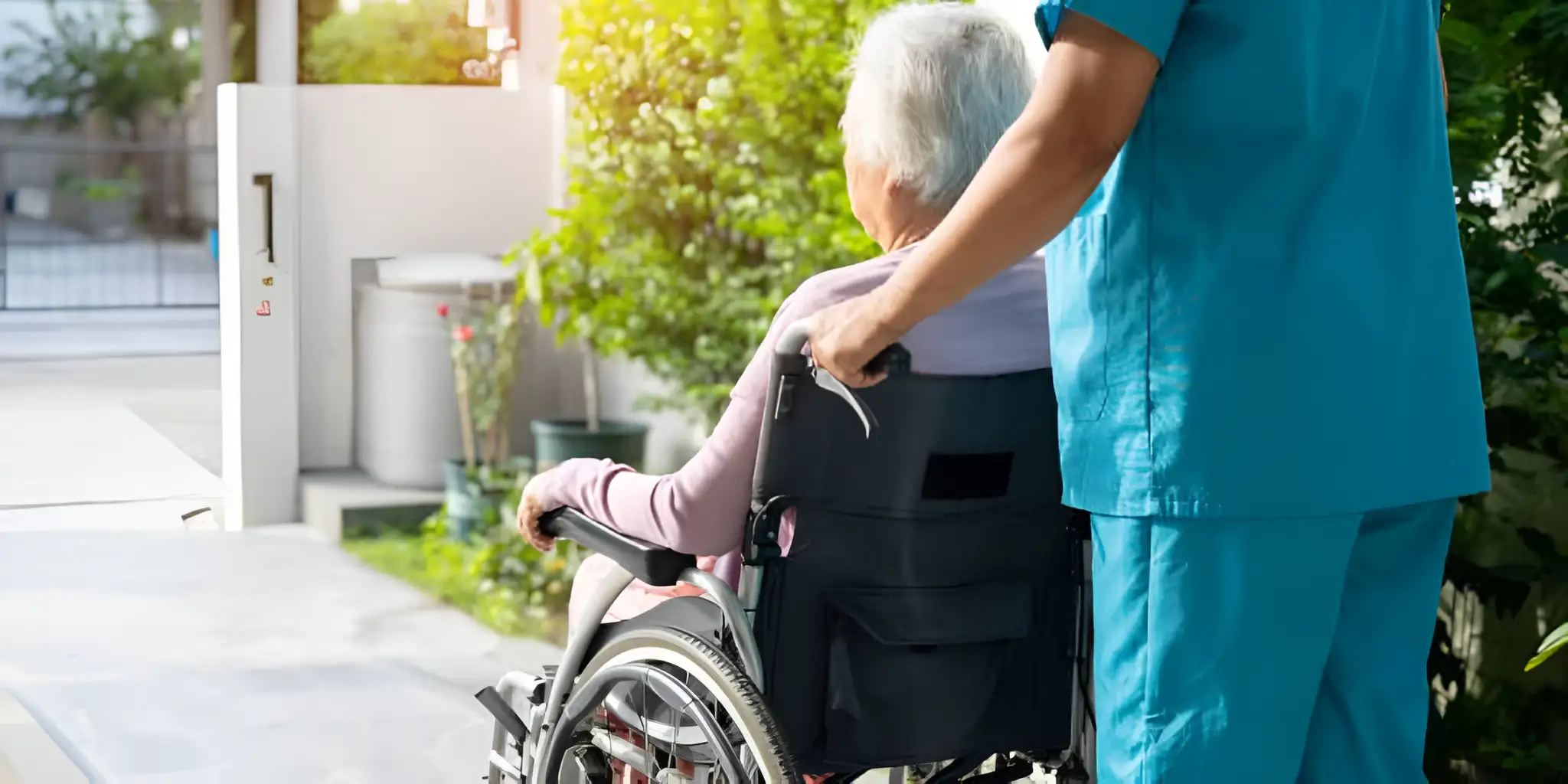 a caregiver is pushing an elderly person in a wheelchair
