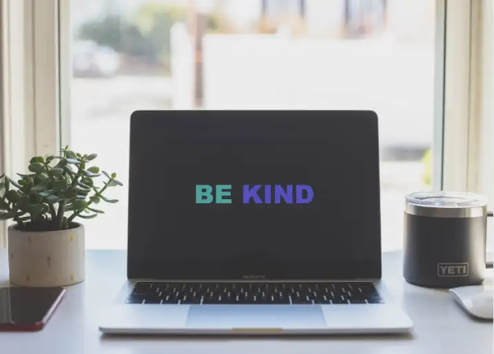 monitor showing 'be kind'