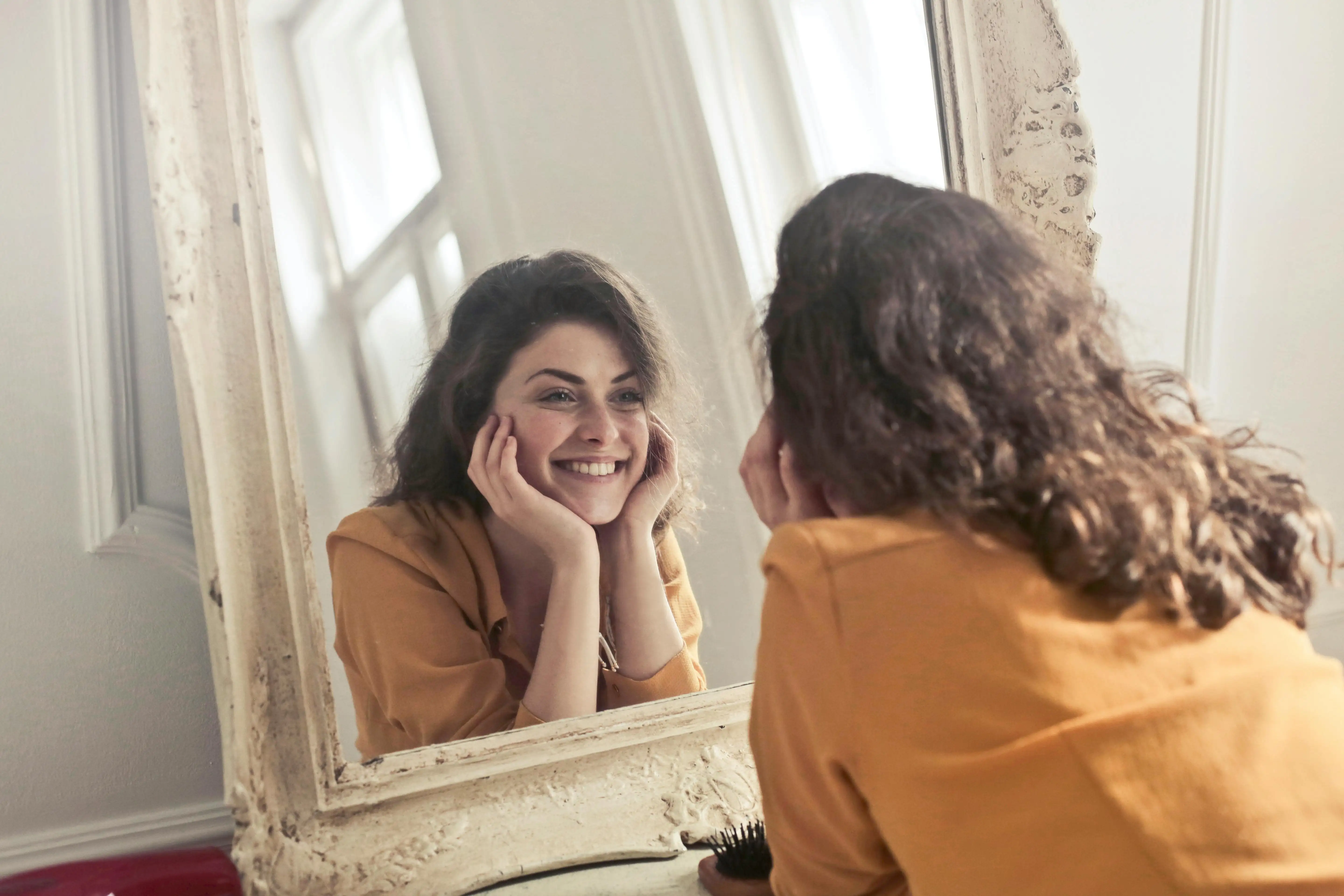 people smiling in front of the mirror