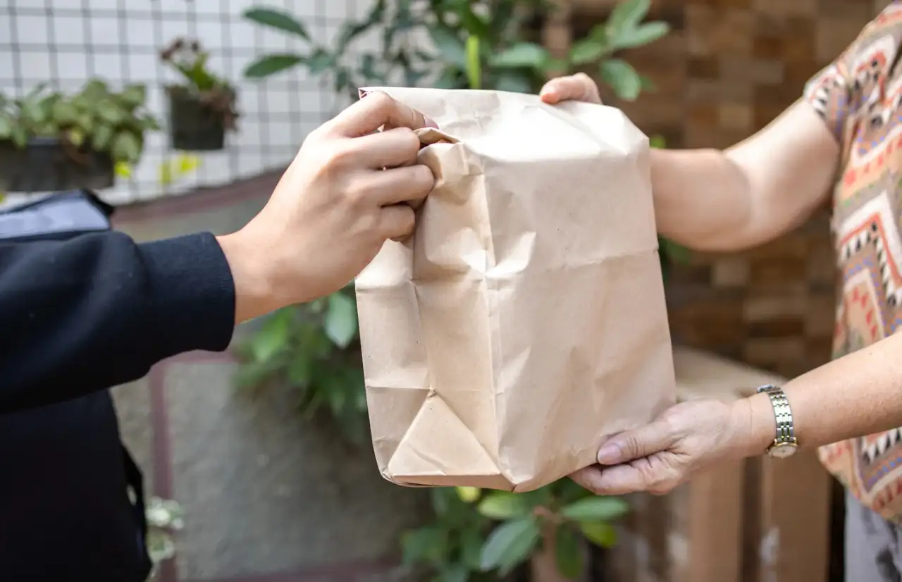 two people handing over package