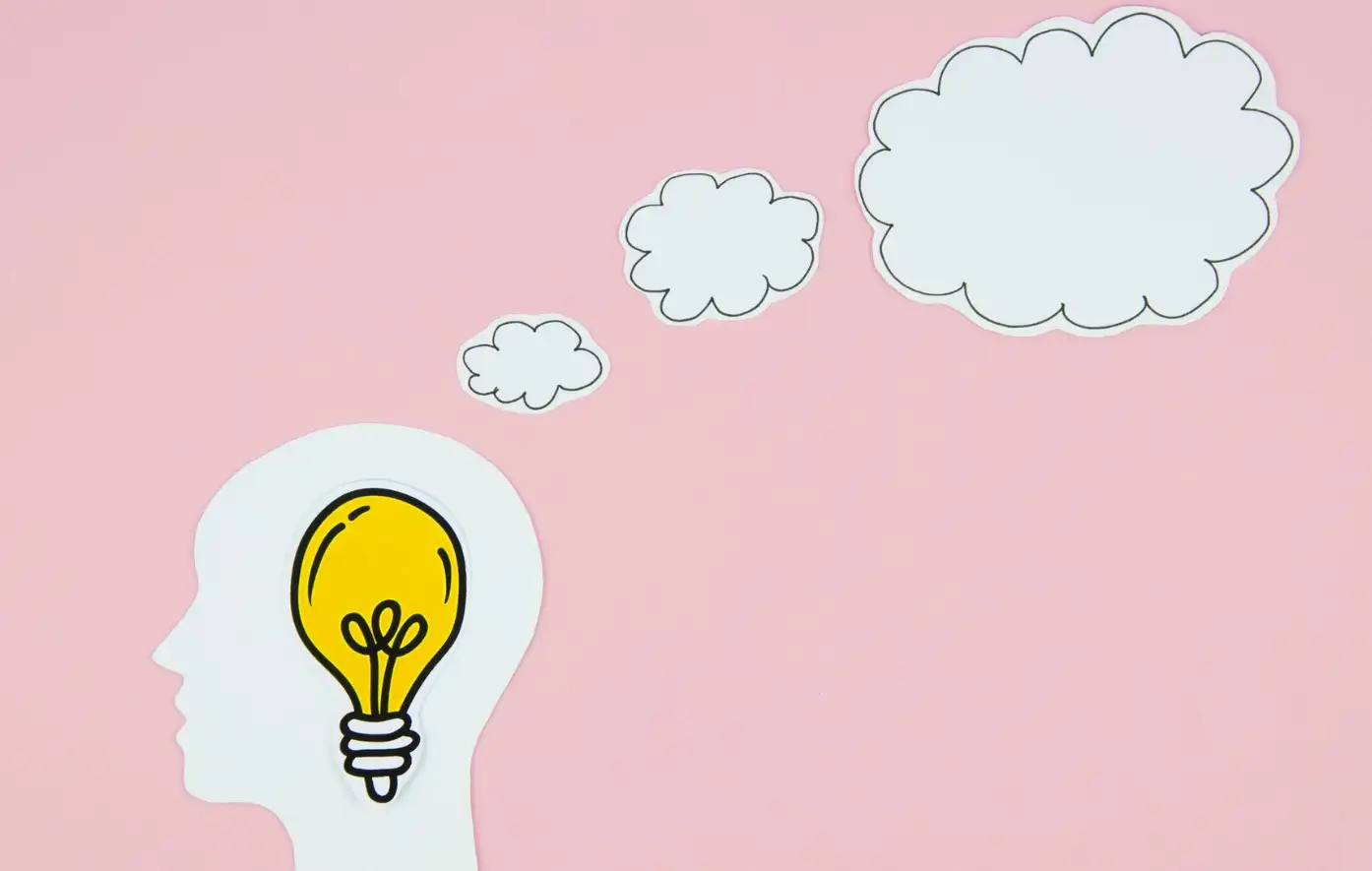 Yellow light bulb in the head with a speech bubble