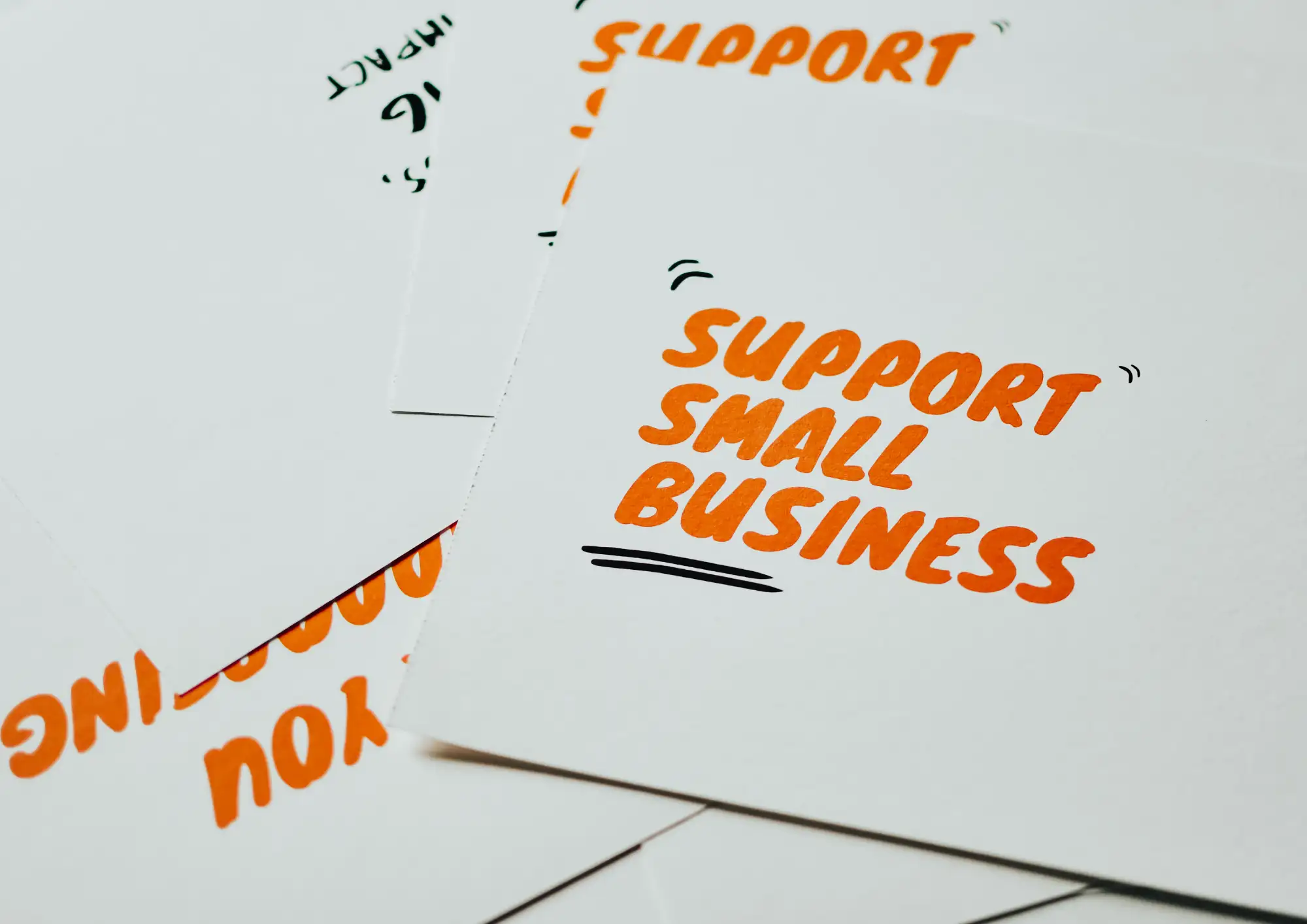 a piece of paper with word 'support small business'