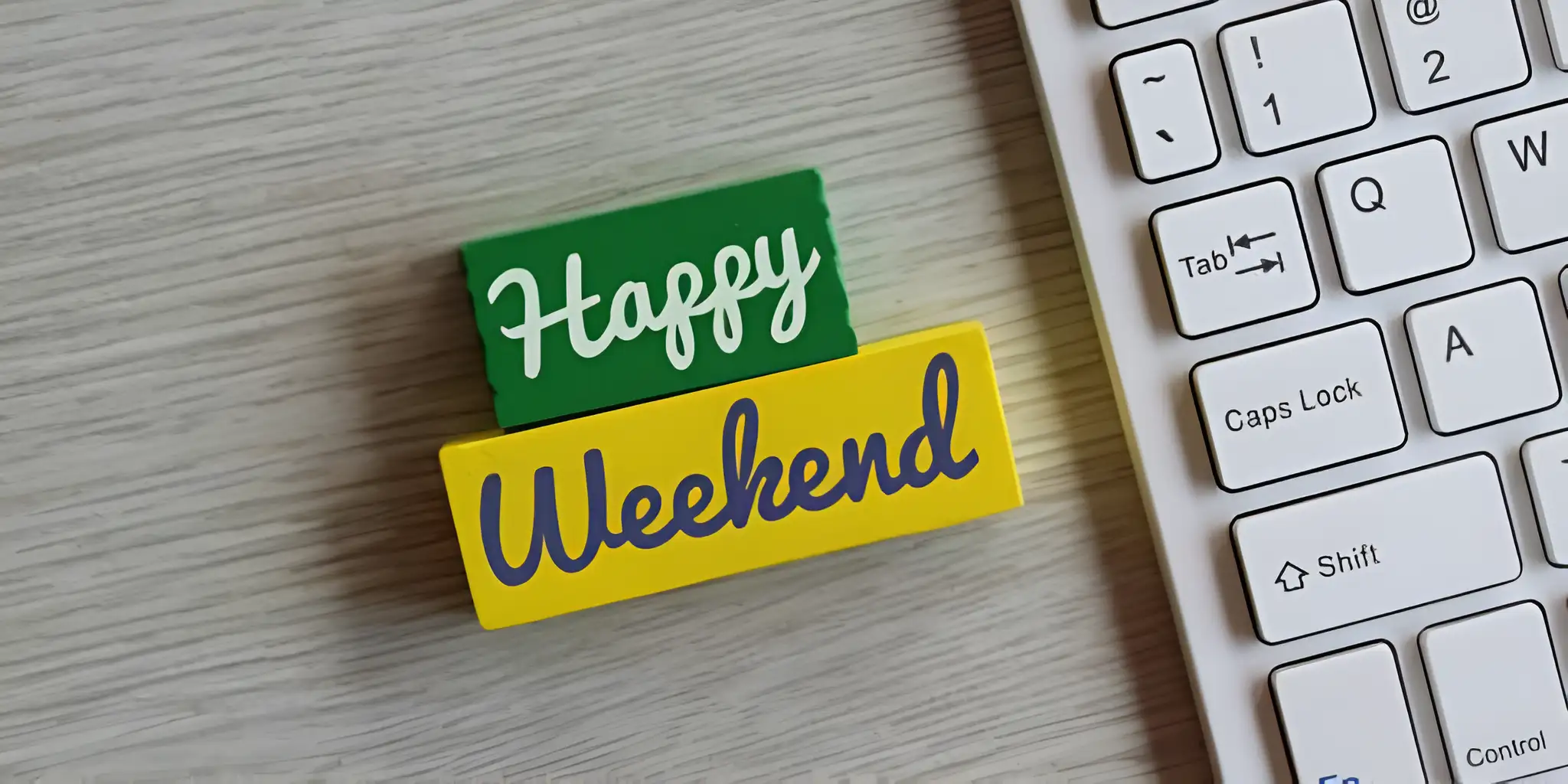 happy weekend building blocks next to the keyboard