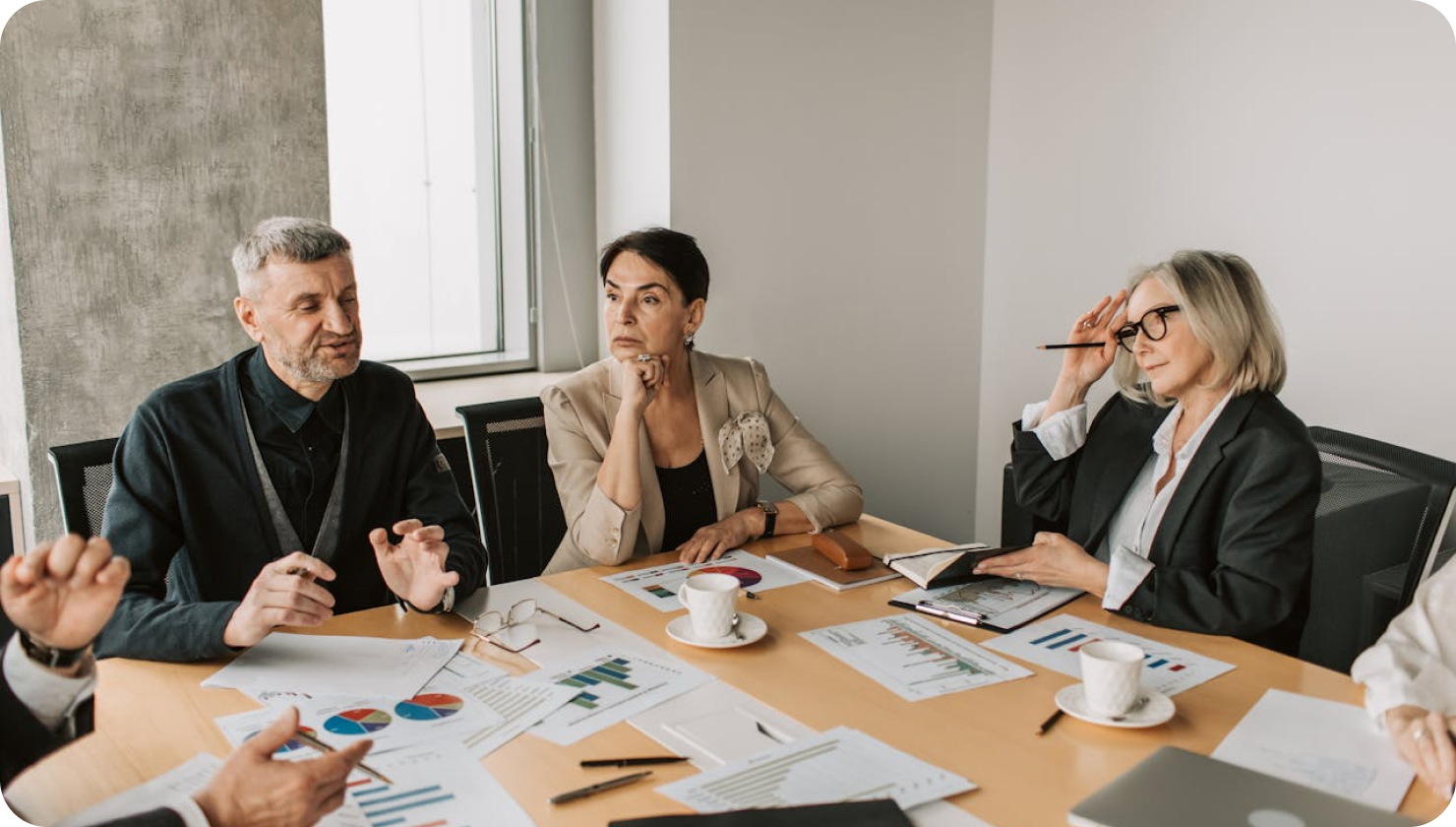 a group of people having a meeting in the office